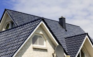 Dark tile roof on a home with dormer and chimney
